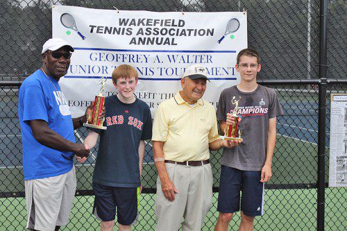 TROPHIES FOR the High School Boys' division were presented at the end of the Geoffrey Walter Jr. Tennis Tournament. From left to right are Bear Hill Tennis Pro Balty Galloway, HS Boys' Champion James Hanron, local tennis legend Pat Zagaria and HS Boys' Finalist Zach Covelle.