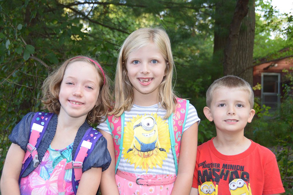 LITTLE SCHOOL STUDENTS Naomi Barber, Hazel Pearsall and Linus Pearsall await the school bus on last week’s first day of school. Naomi and Hazel are in the second grade and Linus is in kindergarten. (Bob Turosz Photo)