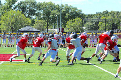 THE RED Raider football team returns from its triumphant 2014 season which brought Melrose to their first Superbowl appearance since 1982. The Raiders, seen scrimmaging on Saturday, open their season Sept. 11 at home against Masconomet. (Donna Larsson photo) 