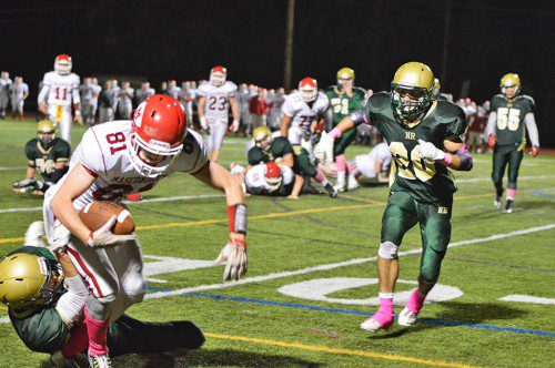 JUNIOR BOB DONAHUE makes a big play in bringing down Masco's Paul Baker inside the 10 yard line in the closing seconds of last week's 14–13 Hornet victory. Number 20 for Hornets is Tom McHugh. (Bob Turosz Photo)
