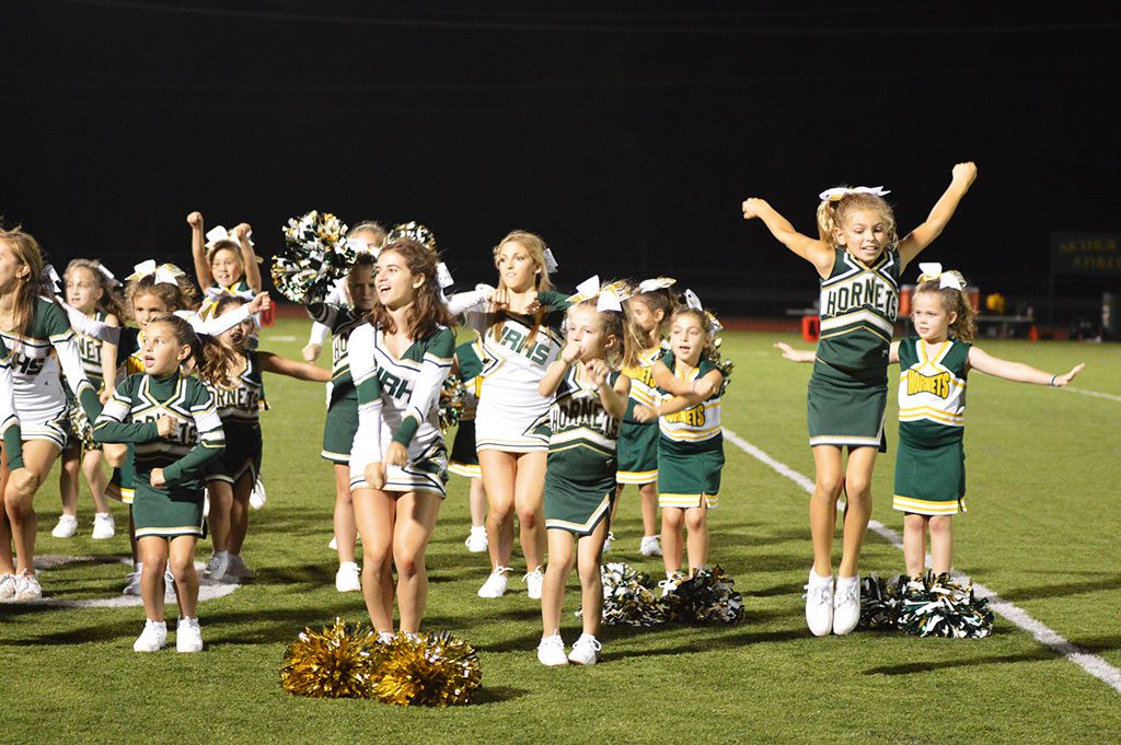 THE HIGH SCHOOL CHEERLEADERS and Youth Football Cheerleaders shared the field at a recent varsity home football game, and both groups had a great time. (Bob Turosz Photo)