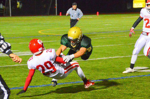 PLAYS LIKE THIS are why the Hornets beat Masco Friday night. Junior Captain John Merullo separates his opponent from the ball on this play in the second quarter. (John Friberg Photo)