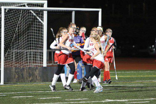 MEMBERS OF the WMHS field hockey team celebrate the fourth goal of the night which was scored by Megan Horrigan (#9). The Warriors won 4-2. (Donna Larsson Photo)