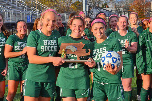JUBILANT HORNETS. NRHS girls varsity soccer captains with the Division 3 North championship trophy. Left to right: Katie Welch, Jordan Schille, and Jill Comeau.(John Friberg Photo)