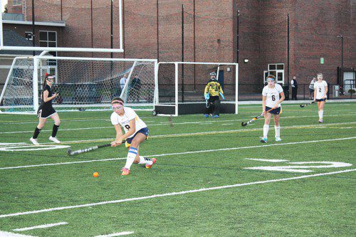 CAPTAIN Lilli Patterson clears the defensive zone during the first 7v7 sudden death overtime period against Marblehead in the state tournament. She later scored the team's only goal on strokes. (Maureen Doherty Photo)