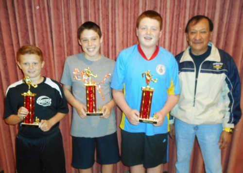 K OF C Soccer Challenge winners with their trophies are (L to R): William Townshend, Logan Cosgrove, and Liam Cosgrove. On the far right is Grand Knight Vinny Gonzales. (Bob Curran Photo)