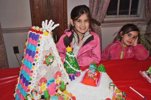 THE winner of the Best Family category in the 11th annual Gingerbread House Contest Dec. 5 was The Norden family. Sisters Calla (left) and Lia Norden proudly display the winning gingerbread house. (Dan Tomasello Photo)