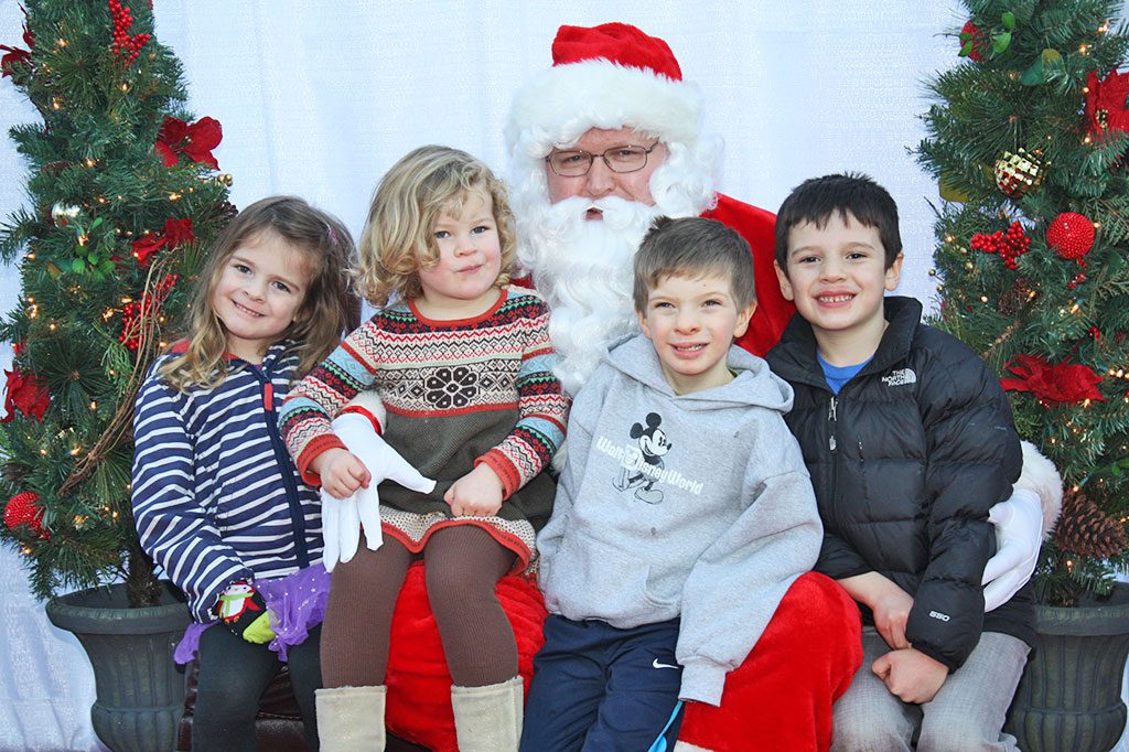 SIBLINGS, from left, Maeve, Brigid, Myles and Coley Walsh were thrilled to tell Santa Claus what they want for Christmas at the Tree Lighting ceremony Dec. 5. (Dan Tomasello Photo)