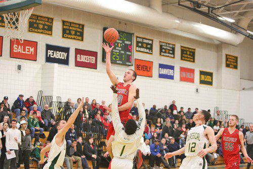 TIGHE BECK, a senior forward, goes up for a basket during last year’s Lynn Classical game as teammate Andrew Auld (right) looks on. (Donna Larsson File Photo)