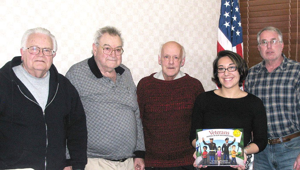 THE VETERANS ADVISORY BOARD wants to give copies of the book, “Veterans: Heroes in Our Neighborhood” to every first grade class in Wakefield. The board liked Wakefield Veterans Services Officer Alicia Reddin’s idea of putting a memorial bookplate inside the front cover of each book with the names of Wakefield servicemen who died for their country. Pictured from the left are Veterans Advisory Board members Dan Benjamin, Tom Collins, Bill Walsh, Veterans Services Officer Alicia Reddin and board member Bob Vincent. Not pictured are board members Arthur Wessels, Rick Pearson and Jay Pinette. (Mark Sardella Photo)