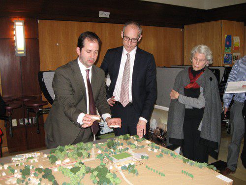 PART 2 of last week's library building project visioning update included using a scale model of the town center and Reedy Meadow to illustrate how building on a portion of the golf course area would impact the site and the neighborhood. The course would remain intact. Kevin Bergeron (left) and Sam Lasky of Rawn Associates explain various options for the site. (Maureen Doherty Photo)