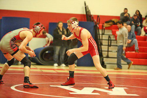 STEVEN MACINTOSH has had a great debut as a freshman on the MHS wrestling team. On January 13 he earned a pin against a Wakefield senior during a Raider/Warrior clash. (Donna Larsson photo)