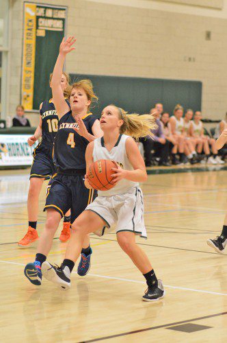 SENIOR KATIE WELCH drives past her Lynnfield opponent on her way to the net. (Bob Turosz Photo)