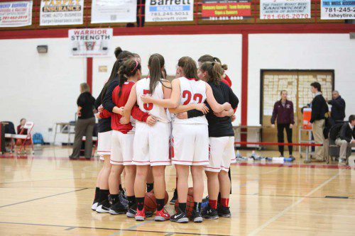 THE PLAYERS on the WMHS girls’ basketball team gather in a circle to gear up for their opponent in a recent contest. The Warriors had a complete team effort and dominated in every facet of the contest against Winchester in a lopsided 52-8 victory yesterday afternoon at the Charbonneau Field House. (Donna Larsson File Photo)