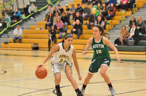 AUSTIN PREP'S scrappy defense gave the Hornets fits all night. But it doesn't stop Hornet junior Kat Hassapis from driving to the basket. (Bob Turosz Photo)