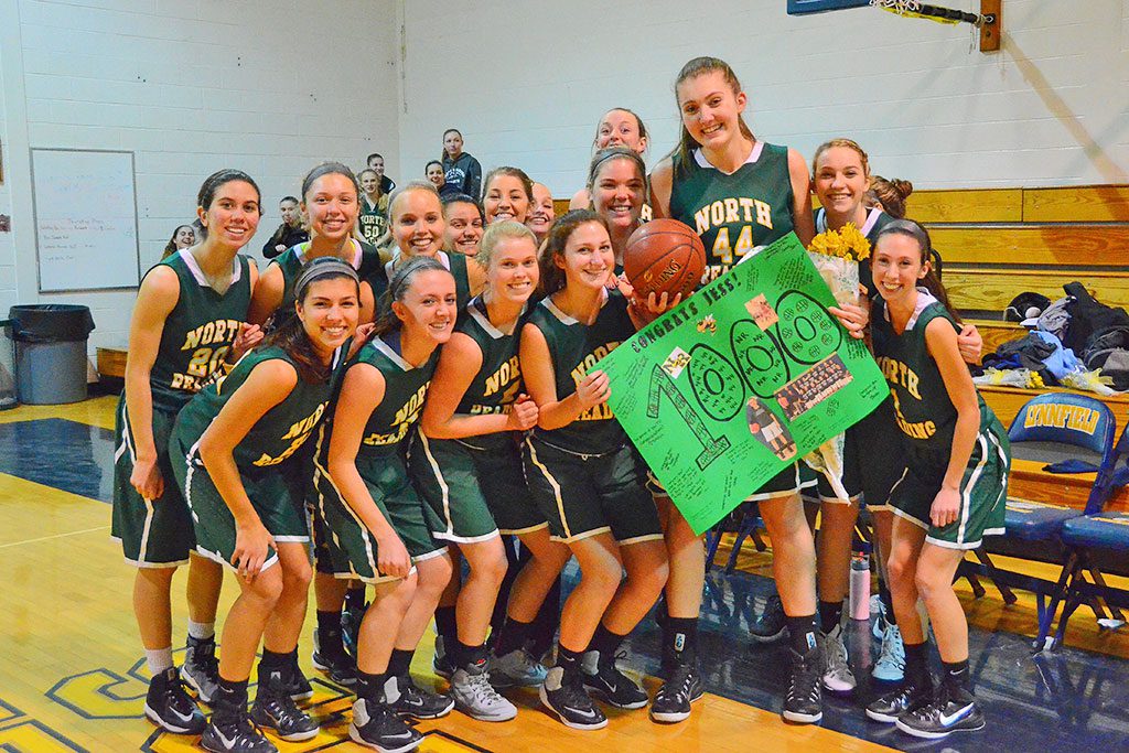 CONGRATULATIONS ARE IN ORDER. The officials stopped the game to allow Hornet senior Jess Lezon to celebrate with her teammates after she scored the 1,000th point against Lynnfield. (John Friberg Photo) 