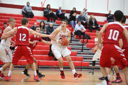 ZACH PRICE, a junior (#24), gave the Warriors a nice lift off the bench with 11 points in Wakefield’s 61-57 triumph over Burlington. Price also did a fine job on defense. (Donna Larsson File Photo)