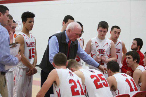 HEAD COACH Brad Simpson (middle) instructs his team during yesterday’s overtime thriller against Melrose. The Warriors went on to win the game, 72-69, to capture the Middlesex League Freedom division title for the second straight year. (Donna Larsson Photo)