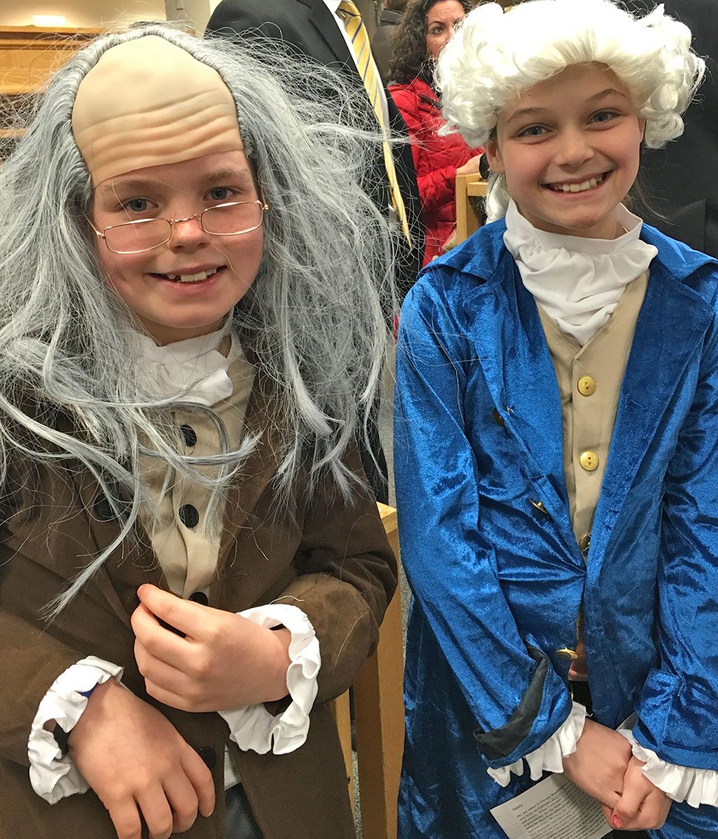 TWO of the country's Founding Fathers, Benjamin Franklin (Drew Damiani) and George Washington (Gabby Jacobs) made a rare appearance at last week's School Committee meeting during which a few students from each school presented a recent project. Damiani and Jacobs presented their fifth-grade project on historical figures and were part of the living wax museum event held recently at LMS. (Courtesy Photo)