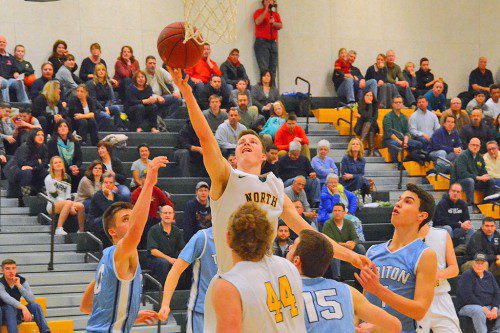 HORNET SENIOR JUSTIN DOROSH rises above the fray to get off this shot in the paint against Triton. (John Friberg Photo)