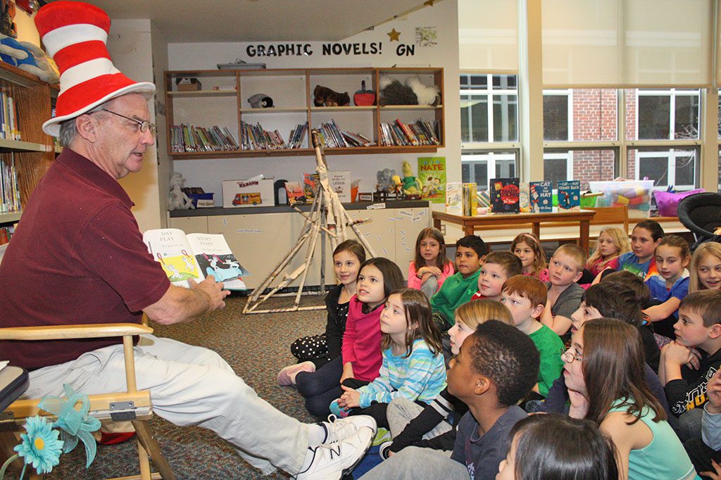 DONNING the classic Dr. Seuss stovepipe hat, beloved P.E. teacher Craig Stone reads “Hop on Pop” to Summer Street School students on March 2, which would have been the 112th birthday of prolific children's author Theodor Seuss Geisel. (Maureen Doherty Photo)