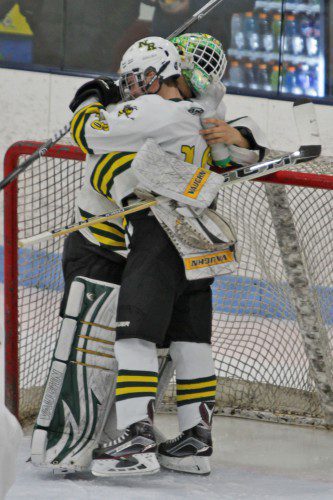 HORNET SENIORS Jason Tannian, (16) and Nick Ponte, (1), longtime friends and teammates, embraced following the team's heartbreaking loss to Lincoln Sudbury in the MIAA tournament quarterfinals. Because they're seniors, this was also their last hockey game in an NRHS uniform. (Stephanie Tannian Photo)