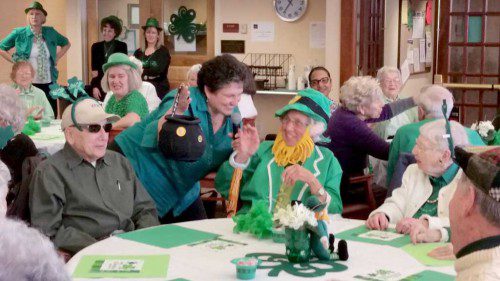 MORE THAN 80 PEOPLE attended the annual St. Patrick’s Day Breakfast at the McCarthy Senior Center on Thursday, March 17. Leprechaun Dotty Robbins  shares her pot of gold (reluctantly) with entertainer Denise Doucette. (Courtesy Photos)