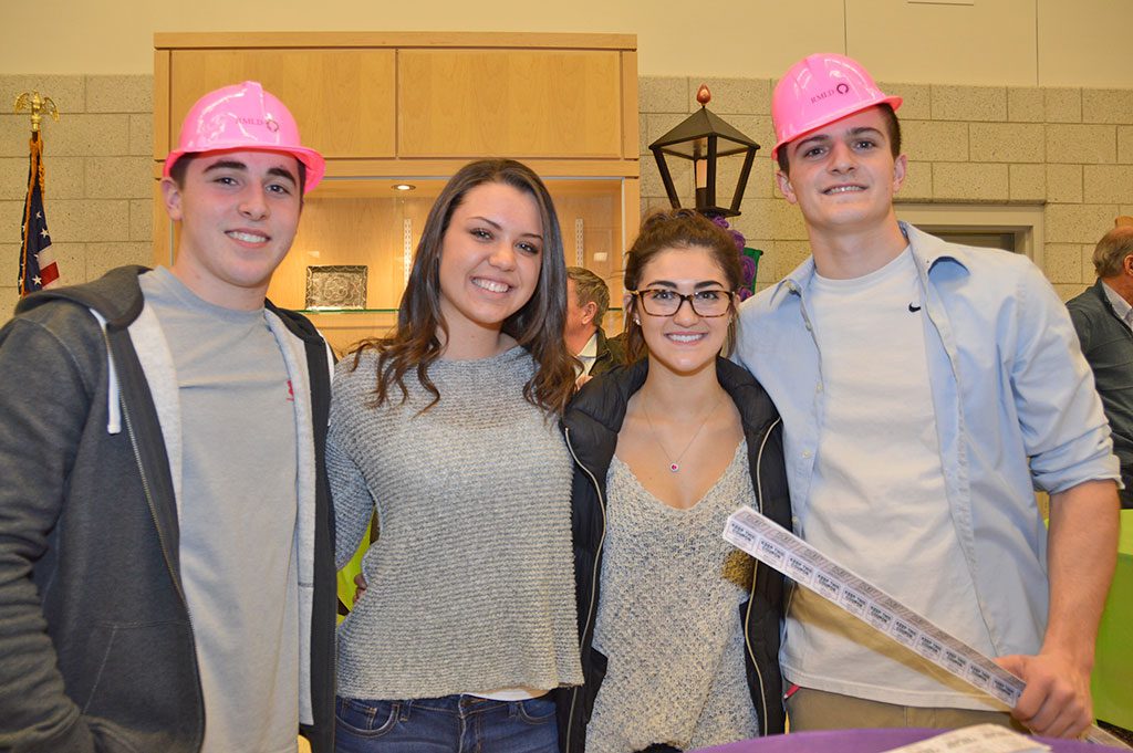THE TASTE OF METRO NORTH, a joint venture of the Reading and North Reading Rotary Clubs, attracted hundreds of people to North Reading High School last week and was a big success. NRHS student volunteers pitching in to help were, (from left): Dylan Beauregard, Courtney Copelas, Domenica DiStasio and Bob Donohue. (Bob Turosz Photo)
