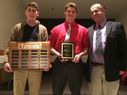 DYLAN MELANSON (center) was presented with the Mark A. Delory Memorial Award at the recent WMHS boys' hockey banquet. On the left is Delory's son, Mark, and on the right is his brother, Michael. The Delory Memorial Award is given to the Warrior boys' hockey player who demonstrates tireless spirit and unselfish play. (Karen Pugsley Photo)