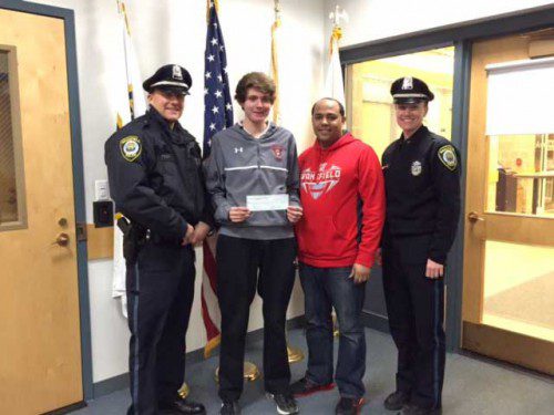 THE WAKEFIELD track boosters received support from the Wakefield Police Officers Association. Accepting the check is senior Alec Rodgers. From left to right are Officer Rob Haladay, Rodgers, WMHS boys' track head coach Ruben Reinoso and Officer Meaghan Leary.