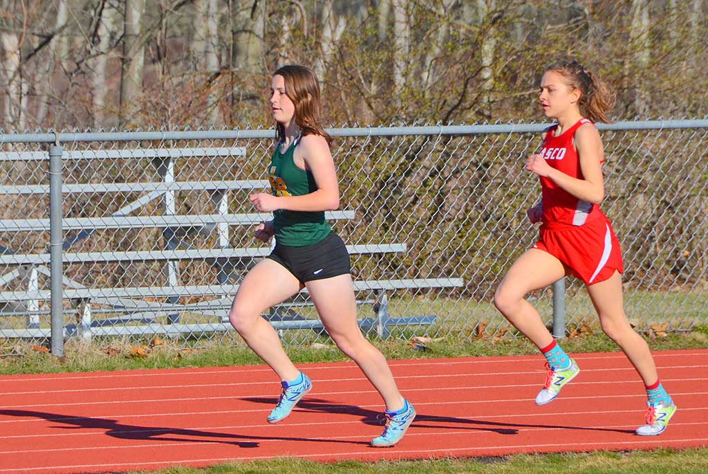 OUT IN FRONT. Hornet Meredith Griffin who was a double winner in the mile (5:28.8) and two mile (12:20.6), as she leads her Masco opponent. (John Friberg Photo)