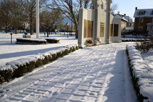 RECENTLY FALLEN SNOW makes quite an impression as it rests on the pathway pavers at the impressive World War II monument at the Veterans Memorial Common. (Robert G. Pushkar Photo)
