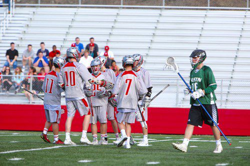 MEMBERS OF the WMHS boys’ lacrosse team celebrate a goal during a recent game. The Warriors had reason to cheer yesterday at Landrigan Field as they defeated Malden Catholic by a 10-5 score. (Donna Larsson File Photo)