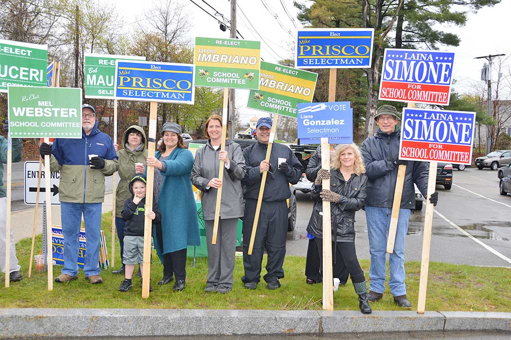 CONTESTED RACES for both Selectman and School Committee brought out a bevy of election signs as voters went to the polls on Tuesday. Despite the contests, turnout was light and when this photo was taken the sign holders outnumbered actual voters inside St. Theresa Church Hall. (Bob Turosz Photo)