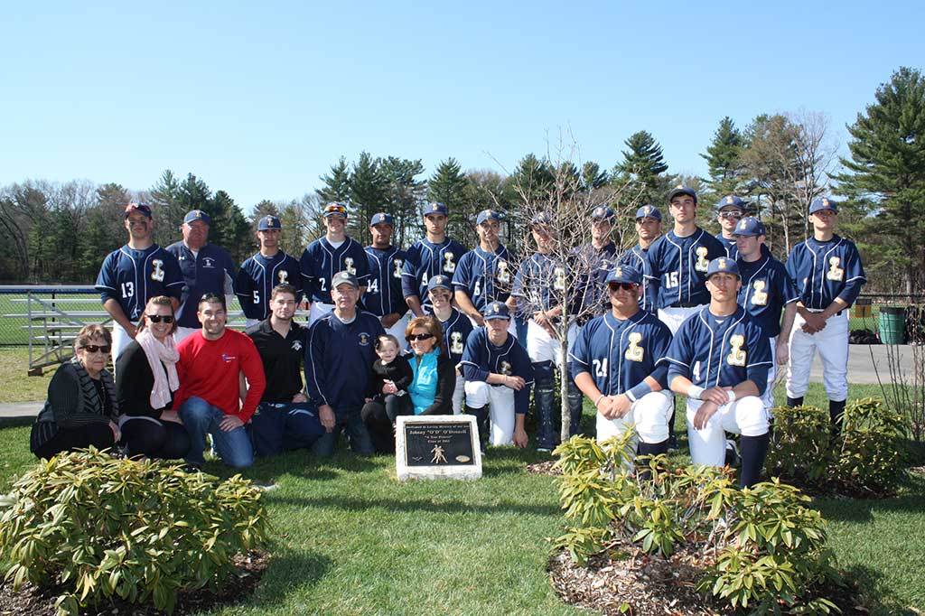 A TRUE Pioneer was honored Saturday when the family of the late Johnny “O’D” O'Donnell, LHS Class of 2003, gathered with the current varsity team, friends and former coaches to re-dedicate the flagpole and memorial garden at the varsity baseball field prior to the team’s 10-1 win over Ipswich. OD’s family members kneeling from left are: his grandmother Mary Martin, his sister-in-law Casey O’Donnell, his brothers Joe and Dan O’Donnell, and his parents, John and Deb O’Donnell with their granddaughter, Grace O’Donnell, 15 months. (Maureen Doherty Photo)