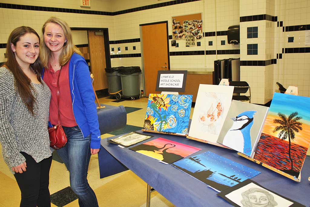 COLLEGE STUDENTS Lea Tremblay (left) and Nicole Davie returned to their old stomping grounds to check out some artwork created by middle school students during Lynnfield High School’s third annual Open Studios Jan. 12. (Dan Tomasello Photo)