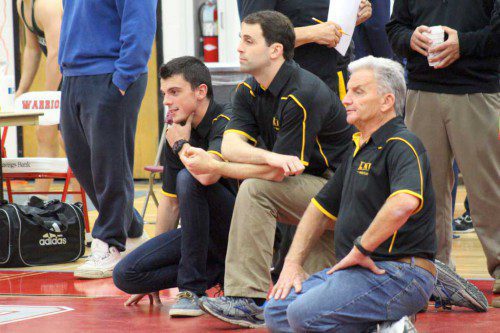LYNNFIELD-NORTH READING co-op wrestling head coach Craig Stone (at right) will be inducted into the National Wrestling Coaches Hall of Fame in a ceremony at Gillette Stadium April 29. Kneeling next to Stone are assistant coaches Matt Goodwin (left) and Nick Secatore. (Courtesy Photo)
