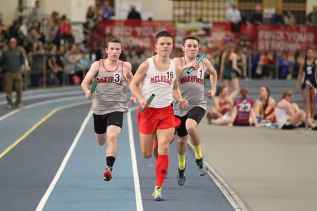 RUNNING THE 400 leg of the distance medley relay are Dan Summers and Brian Smith. Smith was a member of the second place A team and Summer was a member of the B team which finished in seventh place.