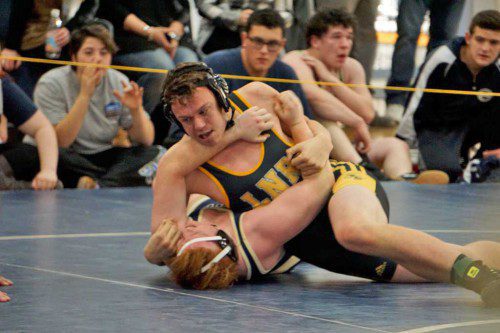 JUNIOR Kevin Farrelly (on top) finished first in the 195 lb. weight class during the Cohasset Tournament Jan. 16. (Courtesy Photo)