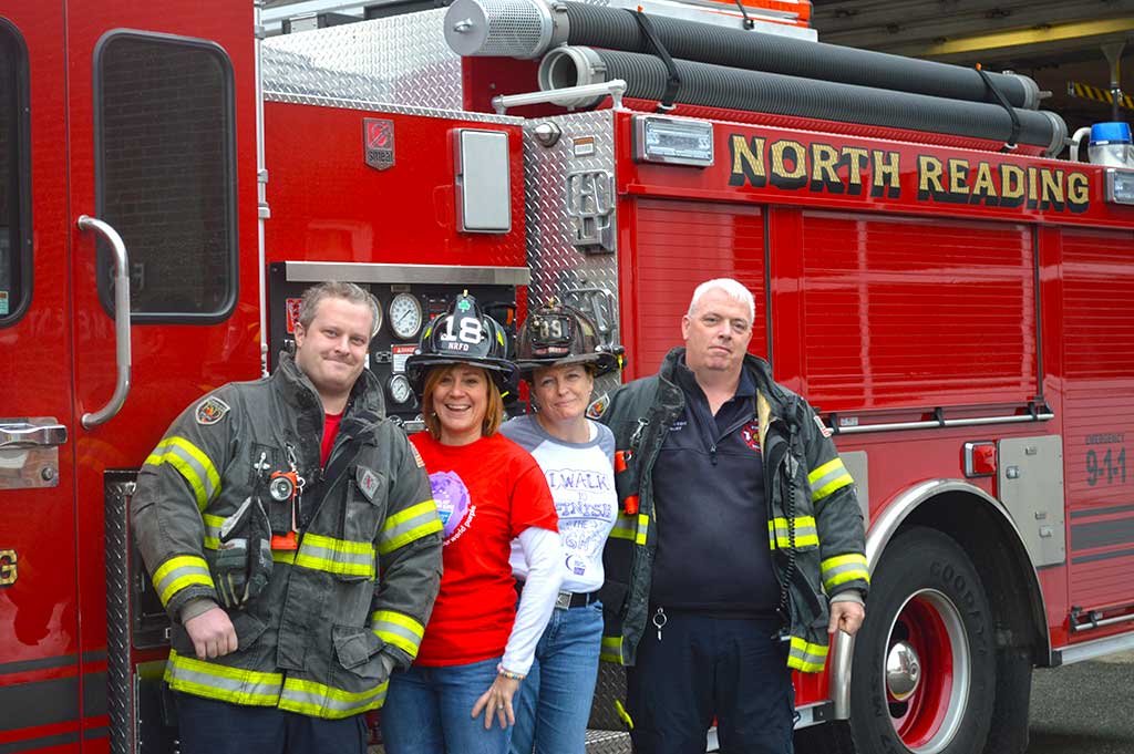 Local volunteers will raise money for the North Reading Relay for Life by pulling a 22-ton fire truck 50 feet next Saturday, April 8. Pictured from left to right; NR Firefighter Tyler Samost, NR Relay for Life Co-Chairs Leanne Valade, Lisa Corsetti and NR Firefighter Jon Burt. (Courtesy Photo)