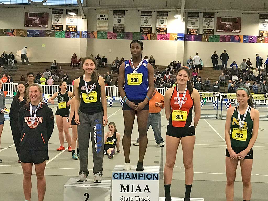 Juliette Nadeau, shown at the top of the podium, won the divisional state long jump championship with a leap of 17’ 6.75” and set a new North Reading High School record in the process. (Courtesy Photo)