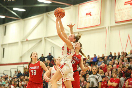 ALLEE PURCELL, a junior forward (#25), goes up for a shot during Friday’s quarterfinal win over Tewksbury as teammate Hailey Lovell (back) and Tewksbury’s Lizzy Gallella (#33) look on while another Redmen player goes for the block. Purcell netted a game high 16 points in the Warrior victory. (Donna Larsson Photo)