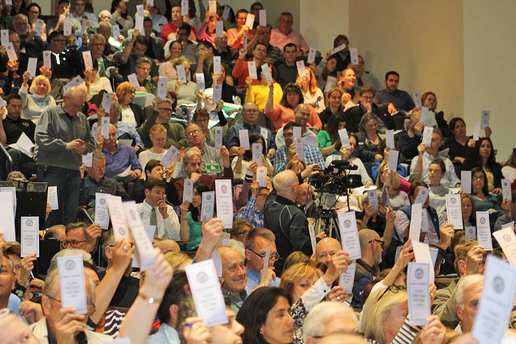 OVER 800 voters packed Monday night's Town Meeting and made plenty of use of their voting cards which are used to help the tabulators take hand counts. (Maureen Doherty Photo) 