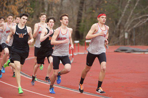 THE WARRIORS swept the mile in their scrimmage meet last Wednesday. In the photo are first place junior Tommy Lucey (far right), second place junior Riley Brackett (second from right), followed by sophomores Billy Stevens and Casey Brackett in back. (Donna Larsson Photo)