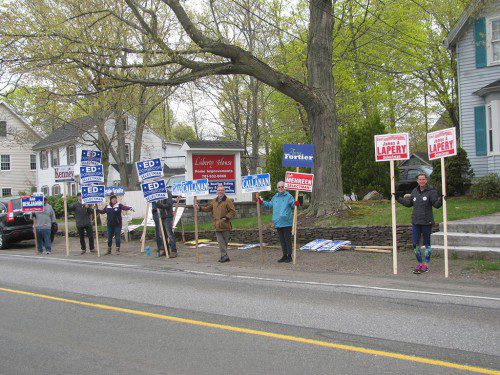 CANDIDATES AND SUPPORTERS were holding signs at 8 a.m. this morning on across from the Masonic Building on Salem Street where precincts 1 and 7 vote. (Mark Sardella Photo)