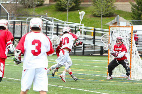 JACK WELLS fires a goal for the Melrose Red Raider lacrosse team, who earned a first ever win over Winchester on Monday. (Donna Larsson photo) 