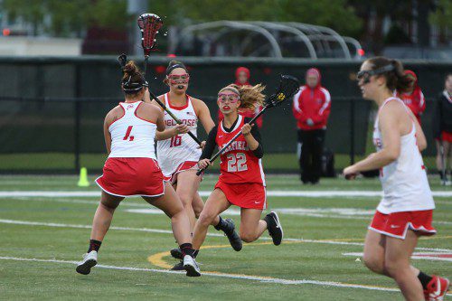 TAYLOR MESSINA, a senior (#22), tallied three goals for the Warriors yesterday against Watertown. Wakefield came up short against the defending league champs, however, by an 11-9 score. (Donna Larsson File Photo)