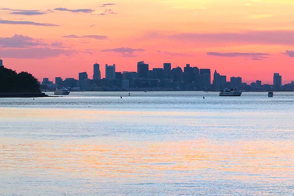 THE SUN SETS ON Boston Harbor and is captured by Wakefield resident John Sofia.