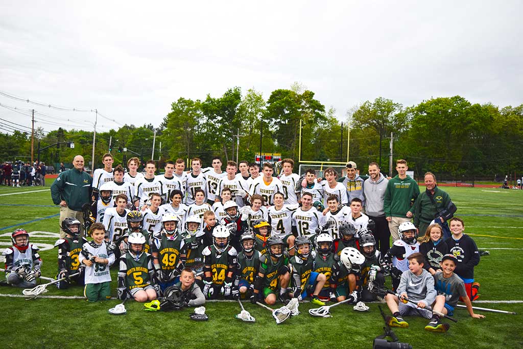 Future North Reading High School lacrosse players posed with current team members after the May 31 playoff game against Essex Tech. (Courtesy Photo/Hornet Super Fan Photo)