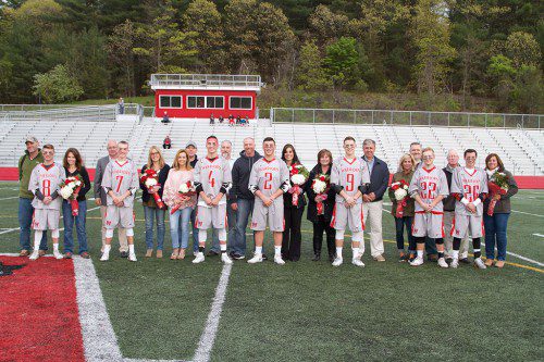 THE WMHS boys’ lacrosse team’s seniors were honored recently at Landrigan Field. The seven seniors are pictured with their families. The seniors (from left to right) are Braedan Langlois, Henry Miller, Austin Collard, PJ Iannuzzi, Pat Leary, Ty Collins, and Justin Sullivan. The Warriors are hoping to earn a win in their first tourney game as they host Malden Catholic in a quarterfinal game tomorrow at Landrigan. (Donna Larsson Photo)